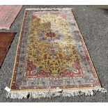 A Persian rug, having central floral medallion with floral borders, 206 x 102cm.