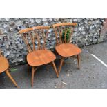 A pair of vintage blonde Ercol candlestick chairs, model 376.