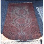 A Persian rug, having two medallions to central field, 134 x 90cm.