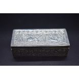 A Colonial white metal rectangular box. having hammered decoration depicting animals in a jungle