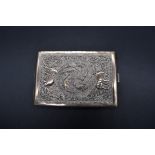 An eastern chased white metal cigarette case, 11.5cm.
