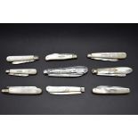 Nine various silver bladed folding fruit knives.