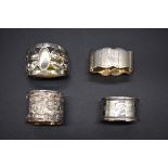 An eastern white metal napkin ring, decorated dragons; together with three silver napkin rings,