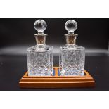 A pair of silver mounted cut glass scent bottles, by A E Jones Ltd, Birmingham 1915, 5cm high, on