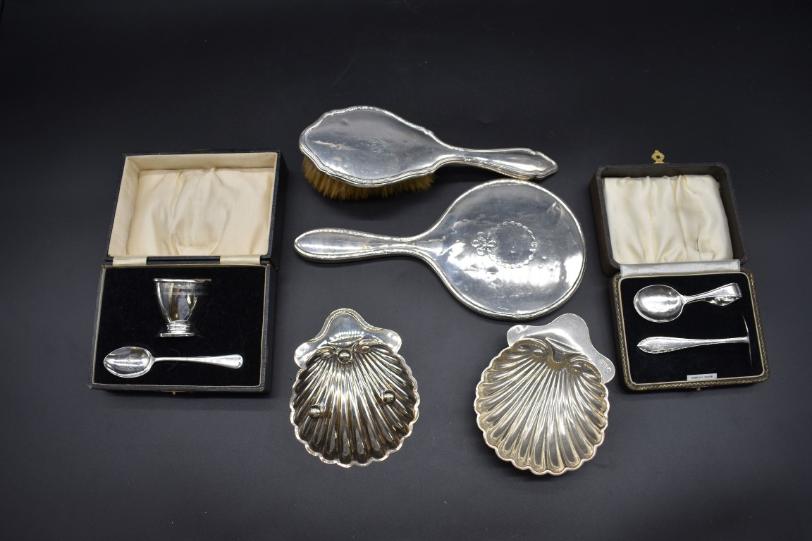 A quantity of silver, comprising: two cased christening sets; a silver hairbrush; a silver hand