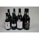 An interesting group of port, comprising: two 75cl bottles of Quarles Harris 1983 vintage, (2in),