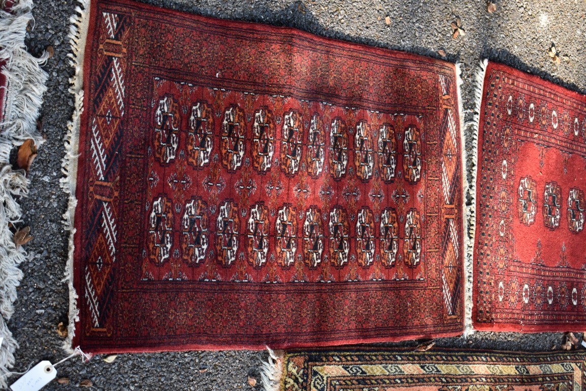 Two small Bokhara rugs; together with another small rug having geometric decoration. - Image 2 of 5