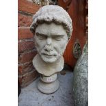 (LC) After the antique, an old weathered composition stone Roman style bust, on socle base, 49cm