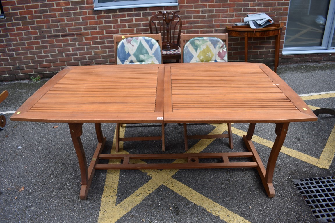 (LC) A hardwood garden table, 262cm extended; together with pair of matching chairs.