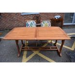 (LC) A hardwood garden table, 262cm extended; together with pair of matching chairs.