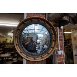 A reproduction gilt framed convex wall mirror, 48cm wide.
