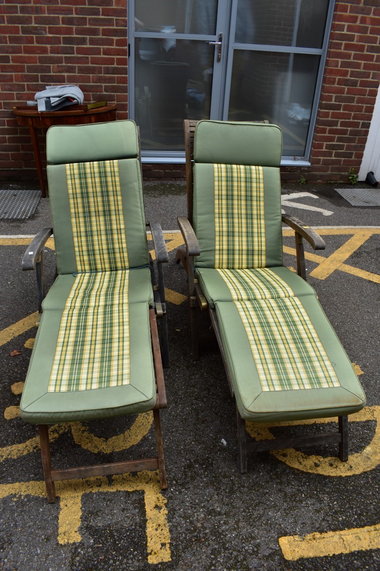 (LC) A pair of teak garden sun loungers.