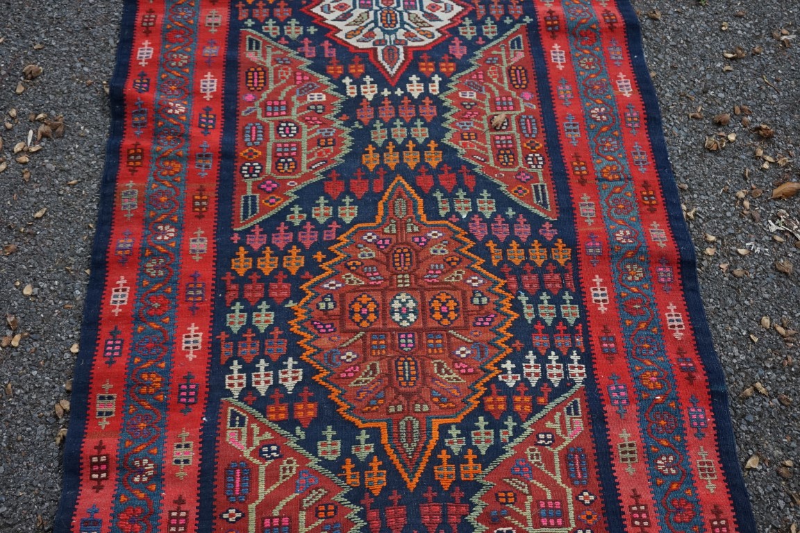 A long Tribal runner, having seven central medallions, with floral borders on a red and blue ground, - Image 7 of 10