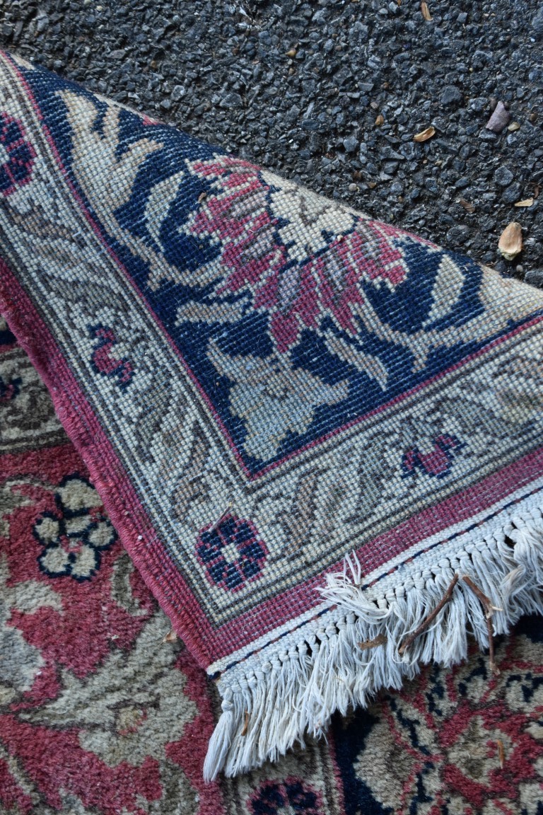 A floral rug, central field decorated with flowers and deer, with floral borders. - Image 3 of 3