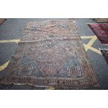 A Persian rug, having central diamond medallion, with sunflowers and geometric decoration to