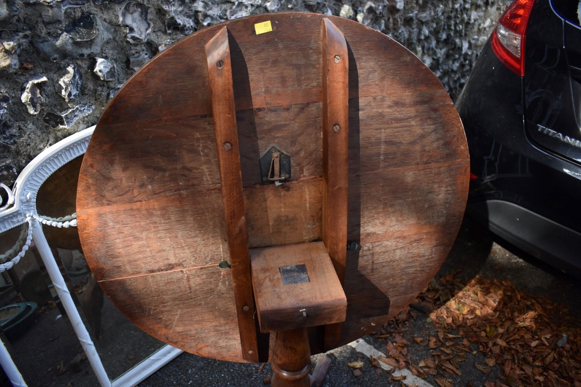 A George III oak circular tripod table. - Image 4 of 4