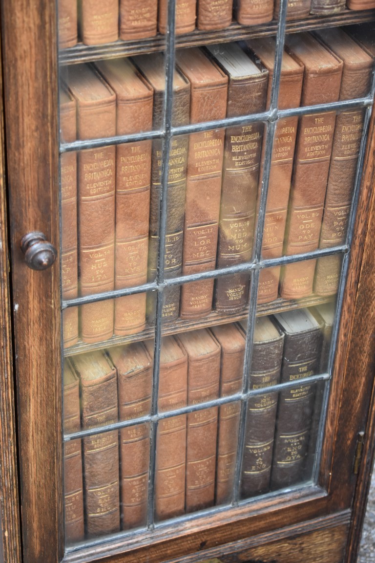 A 1930s oak slim bookcase, containing a quantity of Encyclopaedia Britannica books, 36.5cm wide x - Image 3 of 4