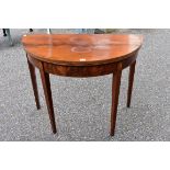 A George III mahogany demi lune card table.