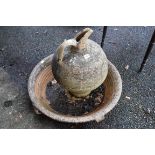 A terracotta garden jug, with matching base.