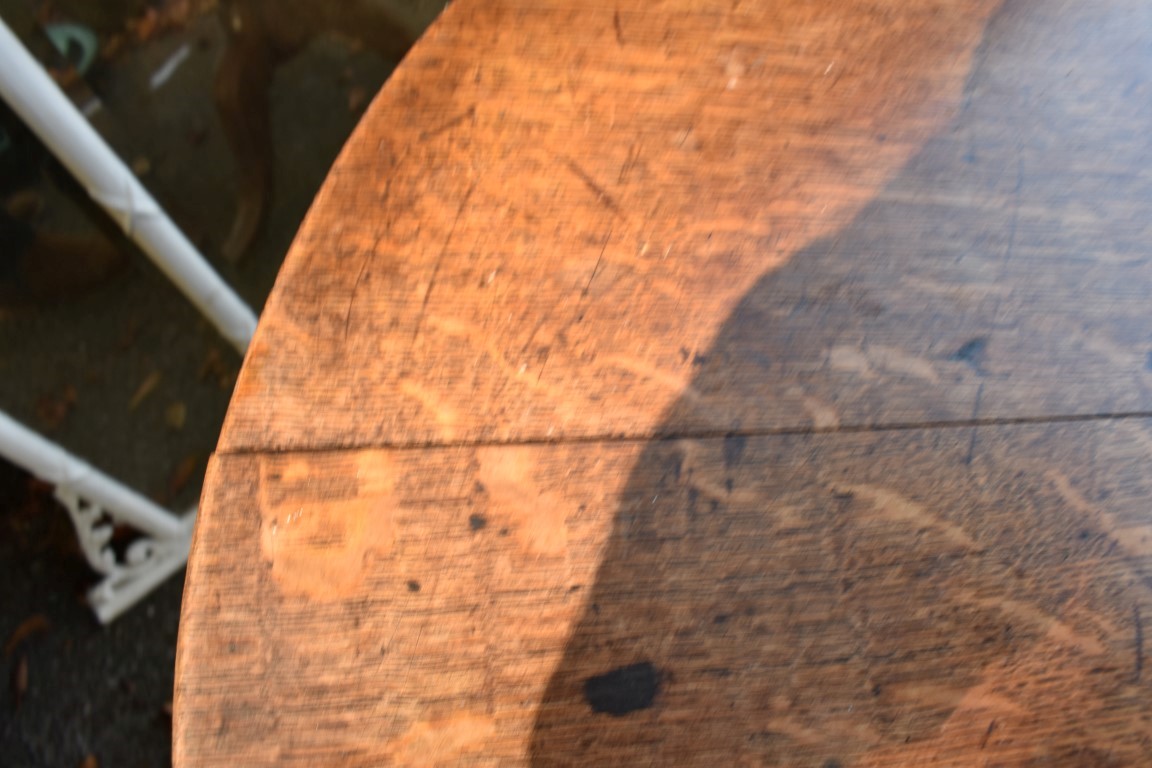 A George III oak circular tripod table. - Image 3 of 4