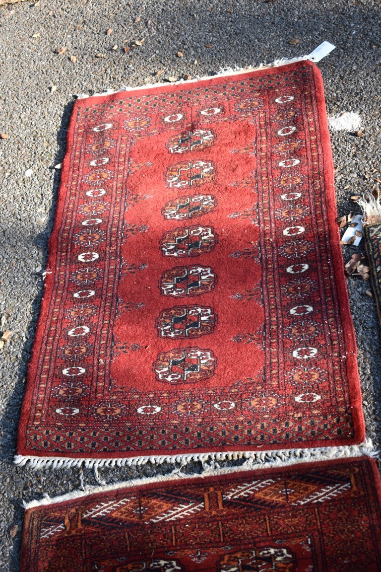 Two small Bokhara rugs; together with another small rug having geometric decoration. - Image 4 of 5