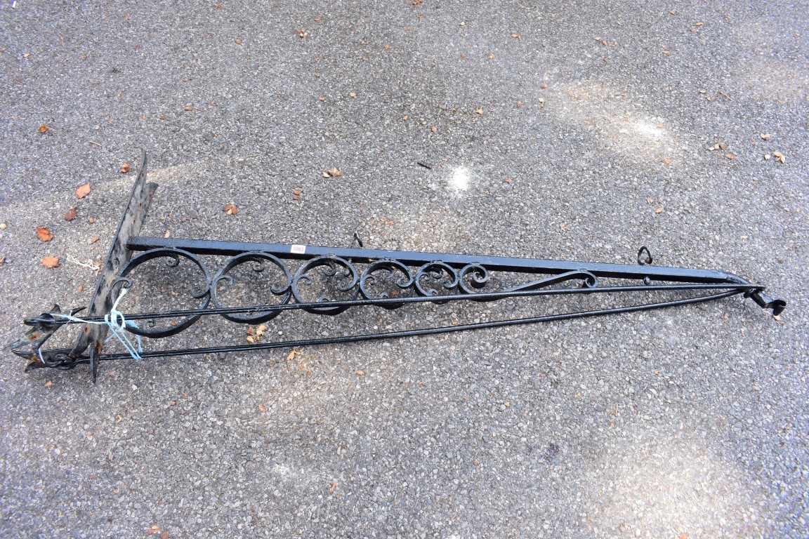 A wrought iron pub sign bracket, 170cm wide.