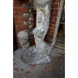 A composition stone sculpture of a female kneeling nude, 89cm high.