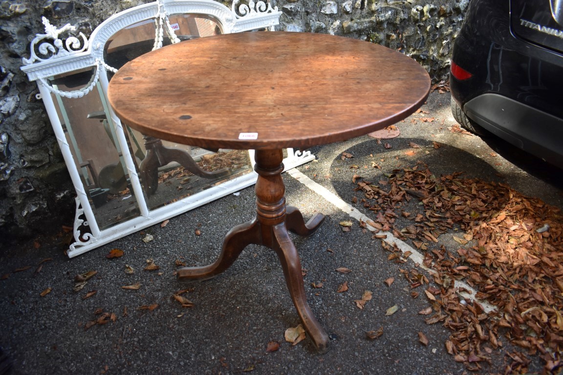 A George III oak circular tripod table.