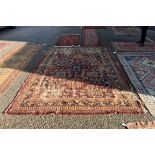 (LC) A large Persian rug, having three central medallions, central field decorated with flowers