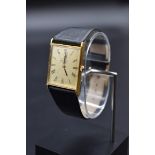 A Van Cleef & Arpels Corum 18k gold manual wind wristwatch, 26mm, on black leather strap.