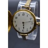 An Edwardian 18ct gold half hunter manual wind wristwatch, import mark 'B & M London 1907', 35mm, on