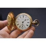 A 14k rolled gold hunter stem wind pocket watch, 50mm, by Waltham, Massachusetts, white enamel dial,
