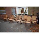 Nine folding garden chairs, having rush seats.