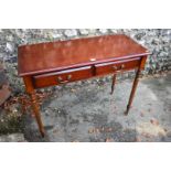 A reproduction mahogany two drawer side table, 100cm wide x 42cm deep x 76cm high.
