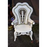 A white painted wicker rocking chair.