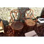 Two antique bentwood chairs, one having cane seat.