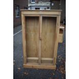 A slim pine bookcase, 153cm wide x 25cm deep x 92cm wide.