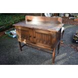 A 1920s oak sideboard, labelled 'Jeffery Sons & Co', having raised back, 123cm wide x 52cm deep x