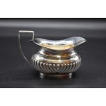 A silver cream jug, by George Nathan & Ridley Hayes, Chester 1913, 9cm high, 164g.