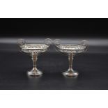 A pair of silver twin handled pedestal dishes, by Walker & Hall, Sheffield, 1908/1912, 10.5cm high x