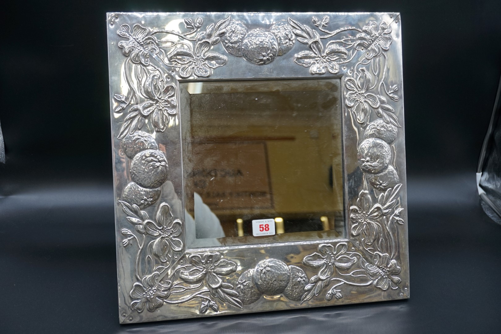 A silver framed easel back mirror, stamped 925, relief decorated with oranges and blossom, 42 x