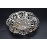 A Chinese pierced silver swing handled basket, by Chong Woo, Hong Kong, decorated with panels of