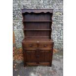 A reproduction oak dresser and rack, 95cm wide x 45cm deep x 178cm high.