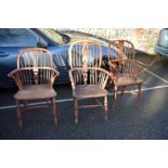 An antique yew and elm Windsor armchair; together with two other Windsor armchairs.