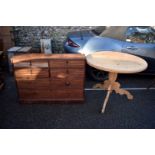A pine breakfast table, on a tripod base 91cm wide x 75cm high; together with a mahogany chest of