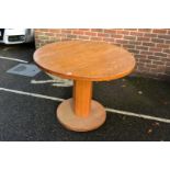 An oak circular dining table, 100cm wide.