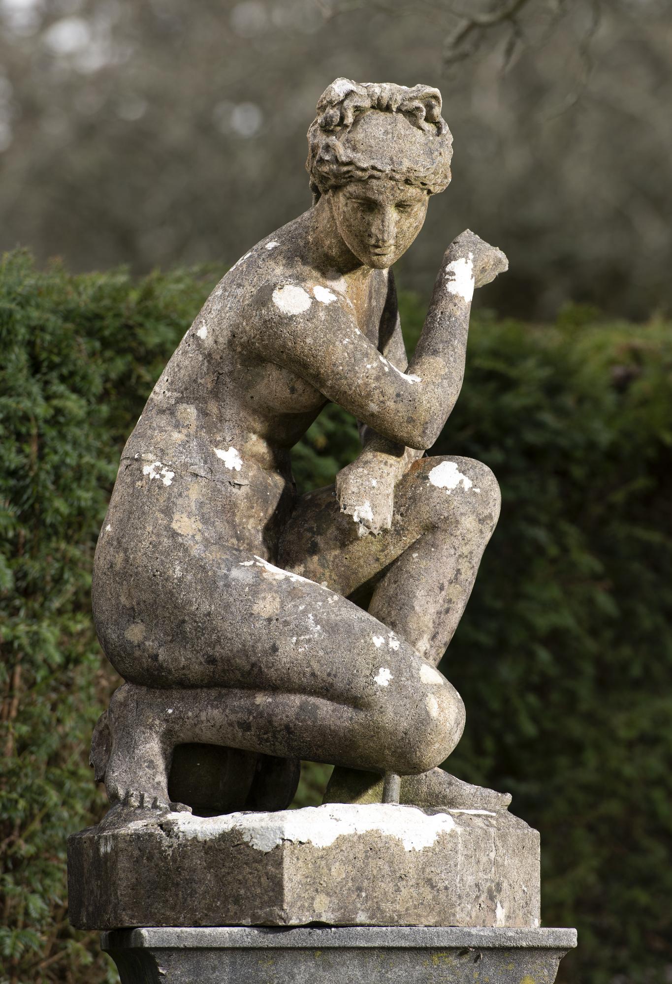 Garden statues: After the Antique: An Austin and Seeley composition stone figure of the crouching