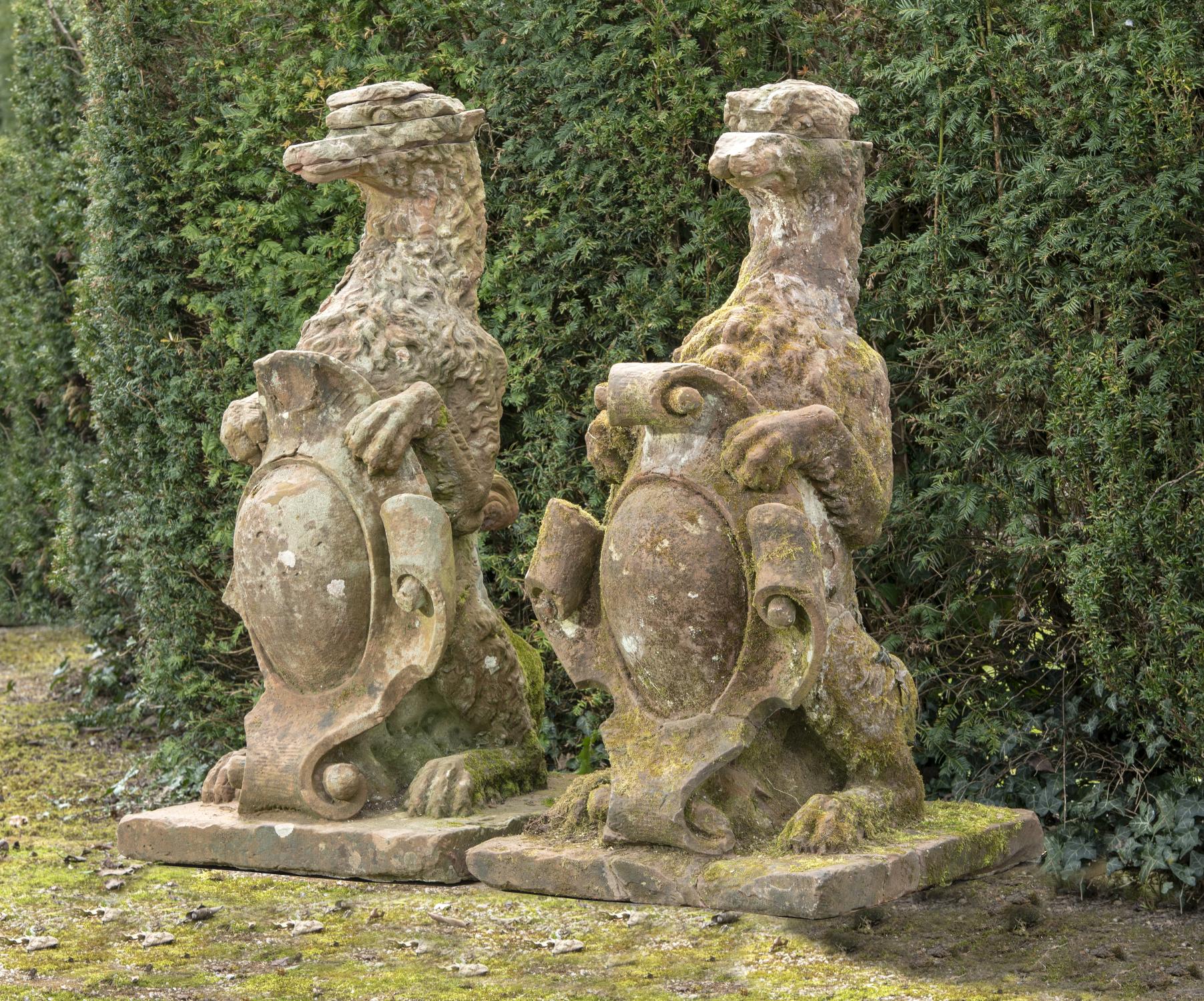 Garden statues: A pair of Victorian carved red sandstone armorial gate pier beasts, circa 1860,