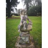 Garden statues: A composition stone figure of the young Bacchus perched on a wine barrel, 2nd half