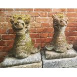 Garden statues: A pair of composition stone armorial grotesque heads, early 20th century, 58cm high,